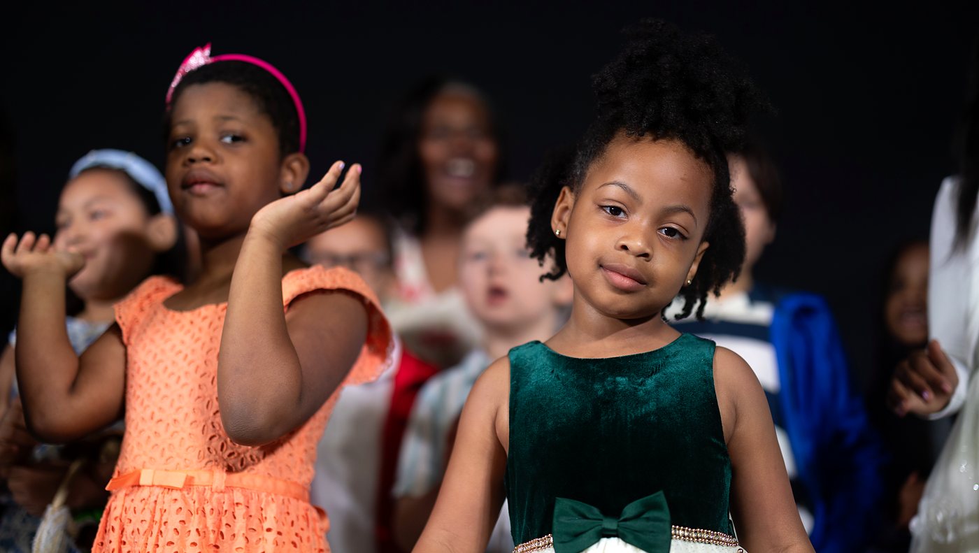 Children singing together during a River Kids performance at NDAC