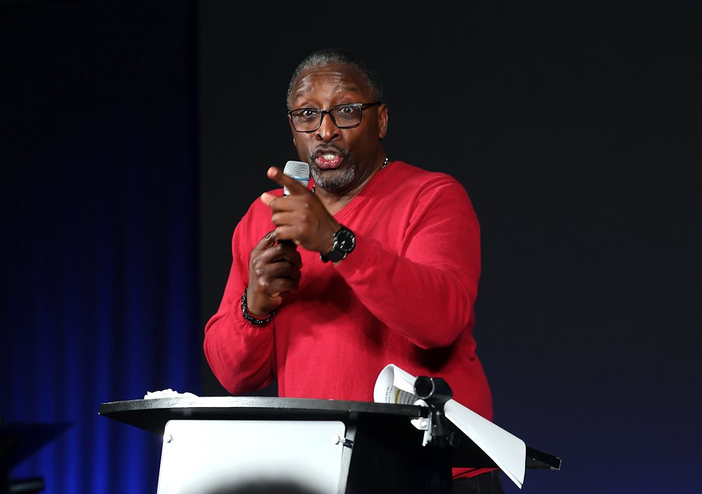 A pastor preaching from the pulpit during a Sunday service at NDAC