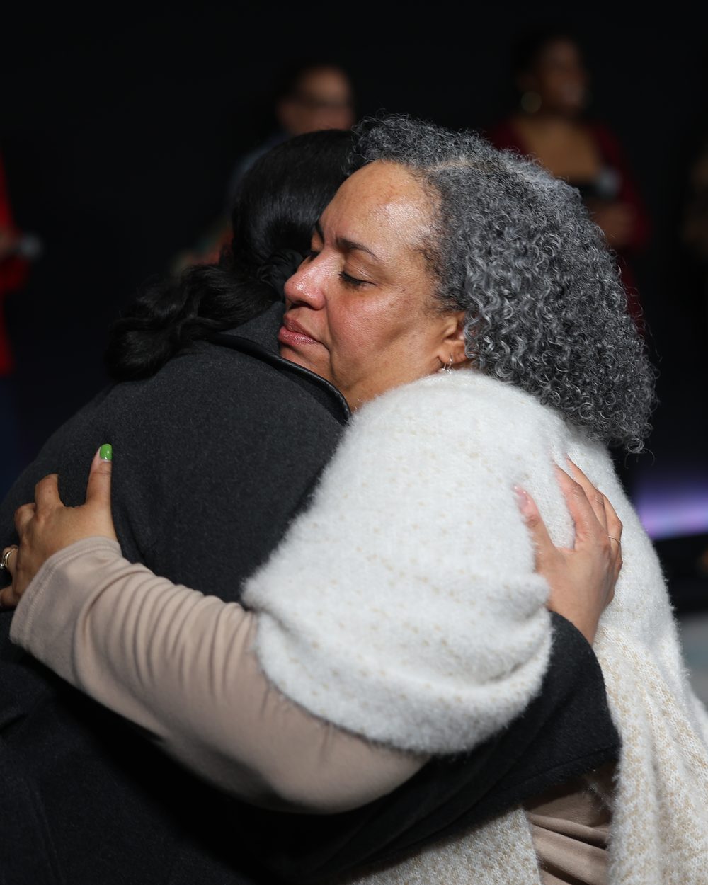 Two church members sharing an embrace during worship