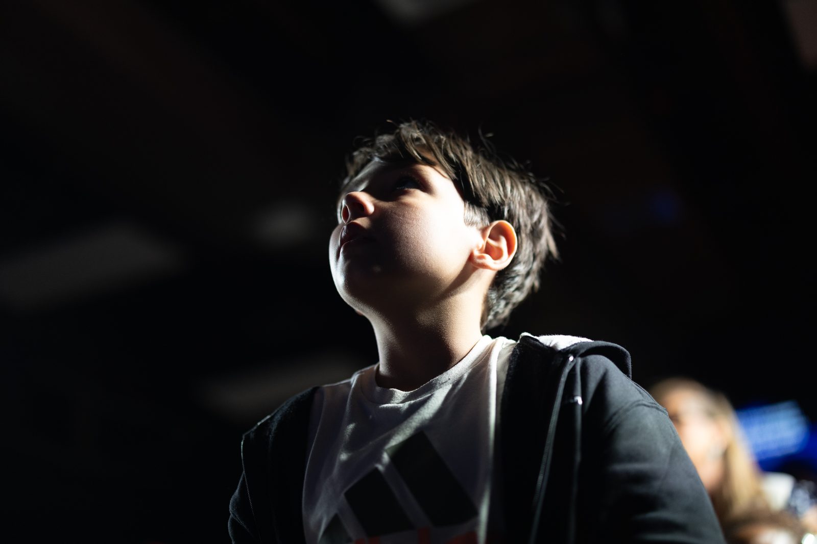 A young boy looking upward during worship