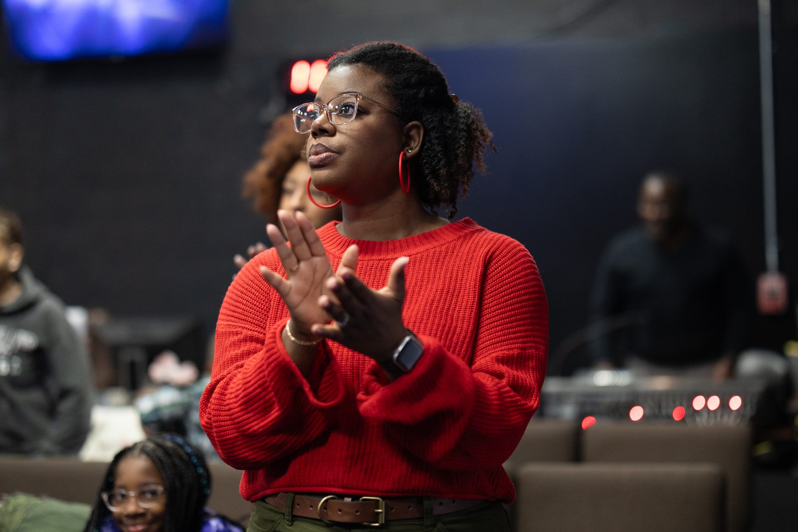 A church member clapping in worship