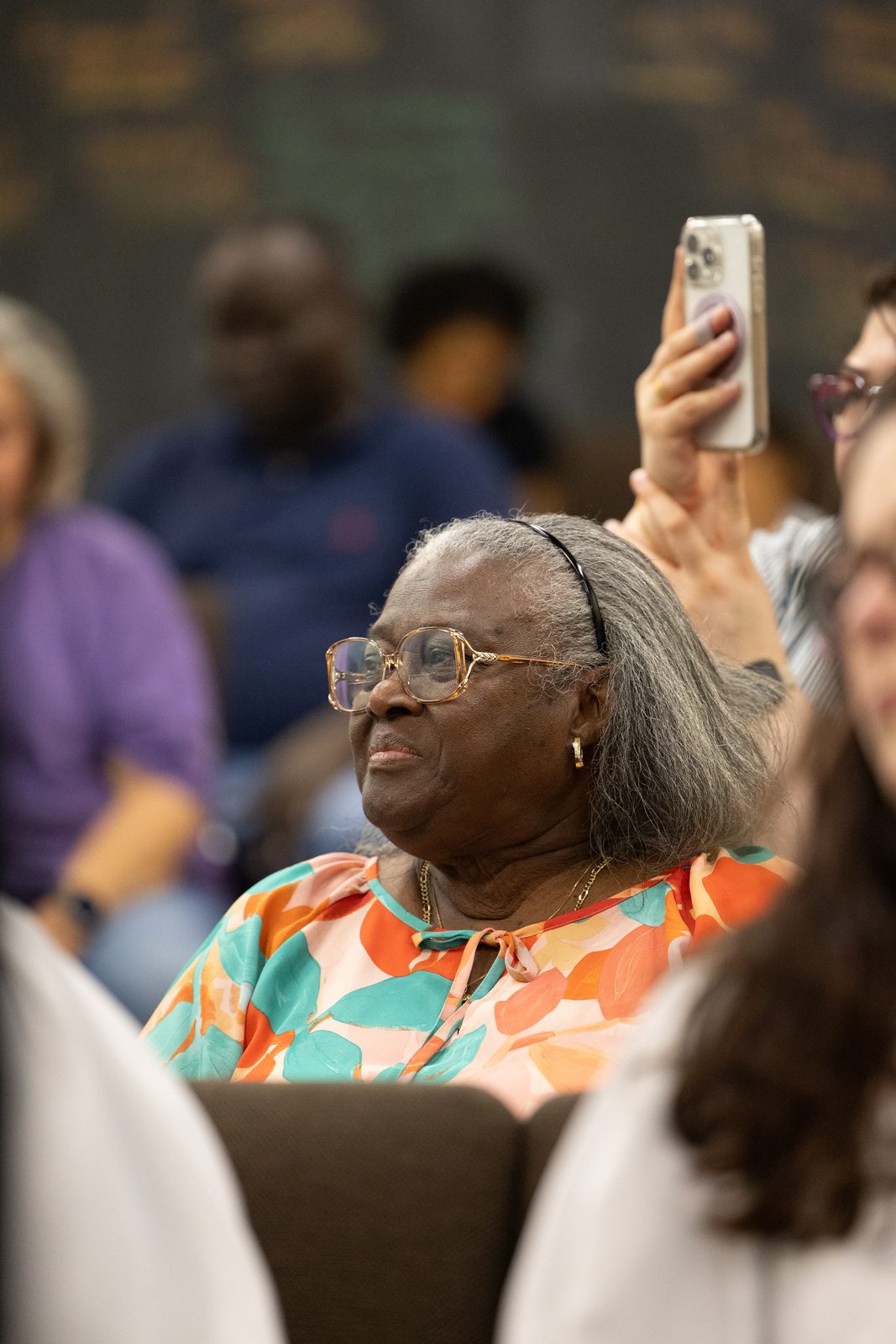 A church member smiling in the congregation during service