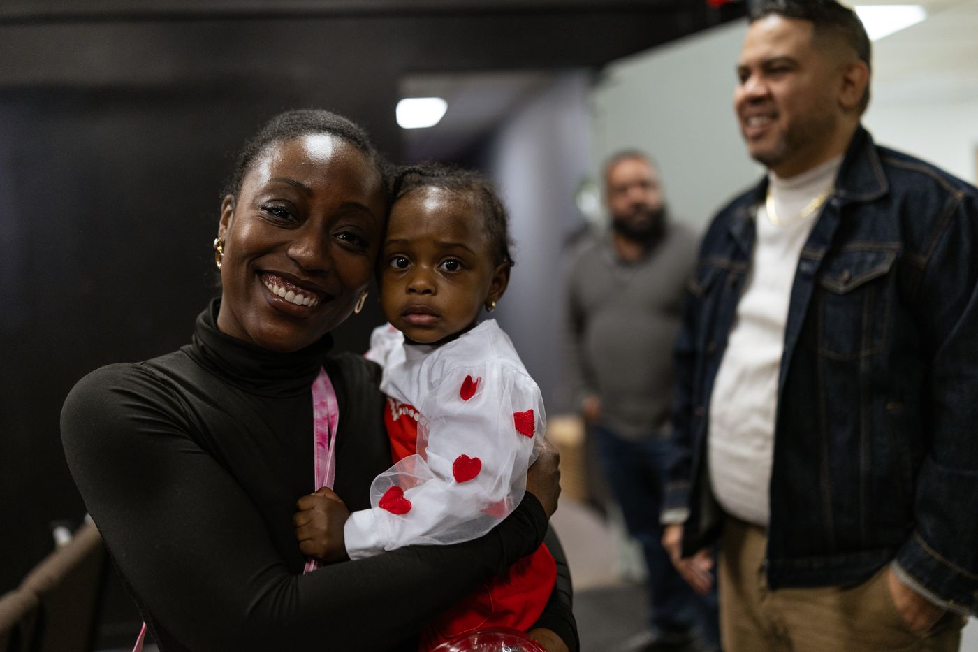 A mother holding her toddler at church