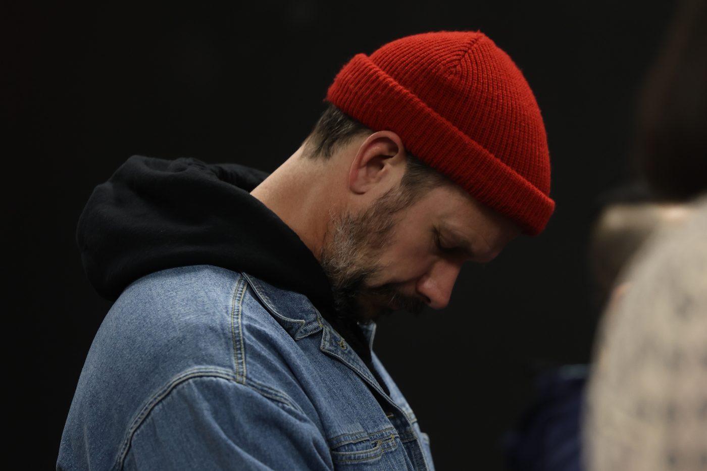 A church member with head bowed in prayer