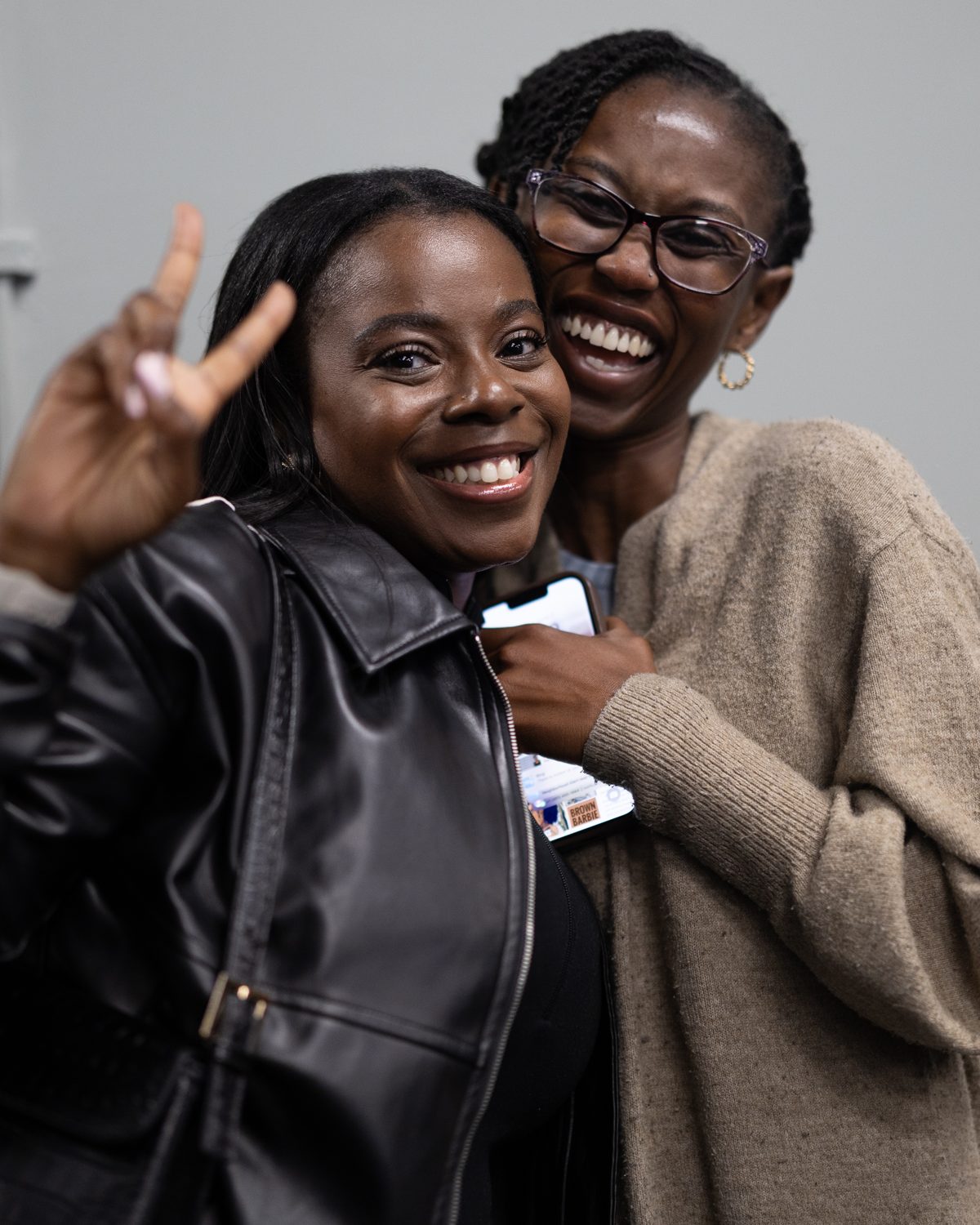Two smiling church members hugging