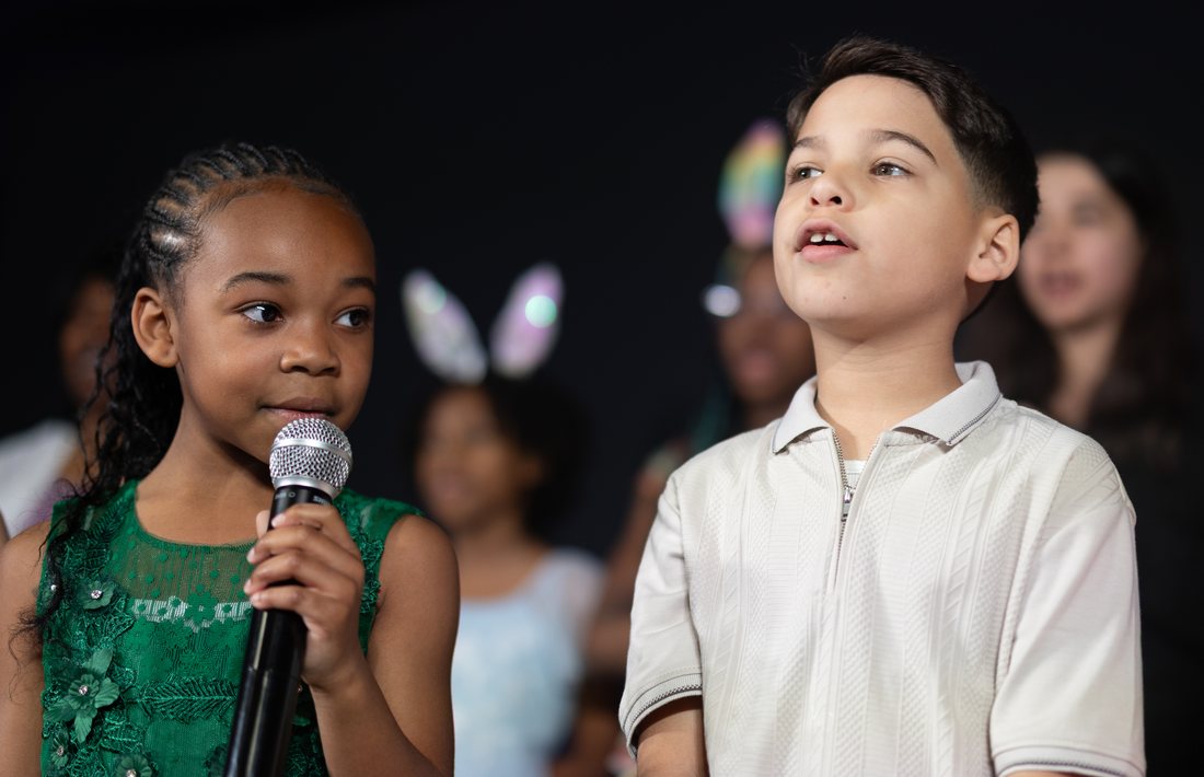 River Kids singing on stage at New Dimension
